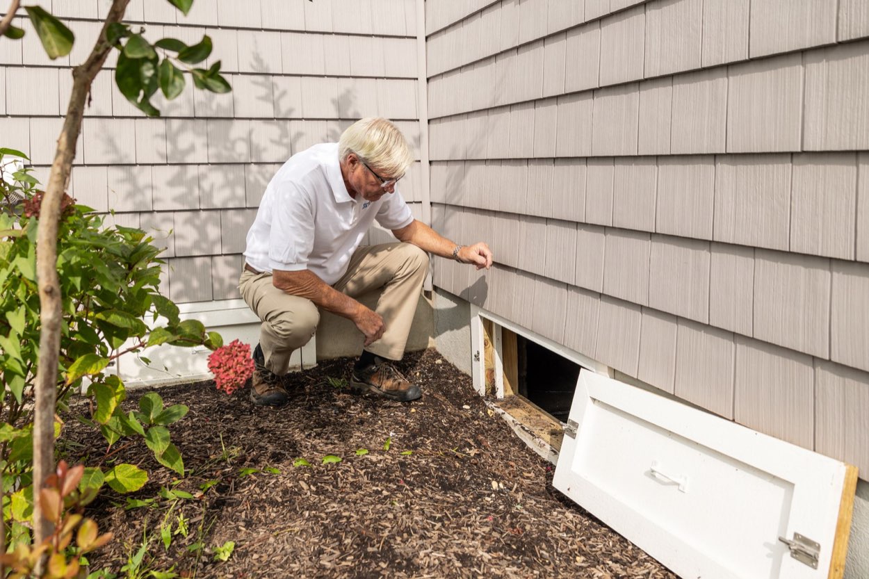 A public adjuster inspecting the exterior of a home